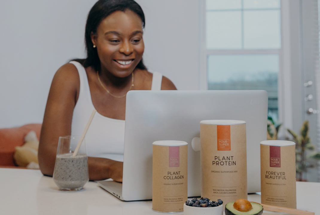 A woman enjoying a Your Super smoothie and taking the quiz